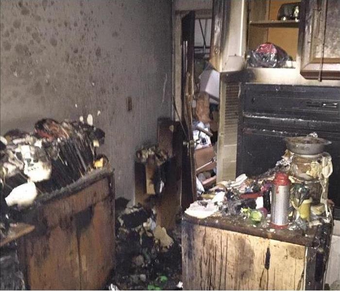 Burned kitchen with debris and soot everywhere