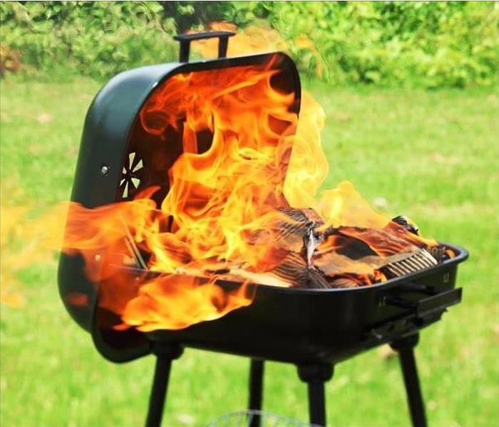 Outdoor grill with flames out of control.