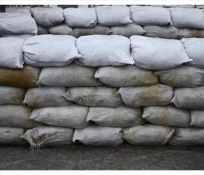 Stacked sandbags, used to help prevent flooding to the interiors of properties.